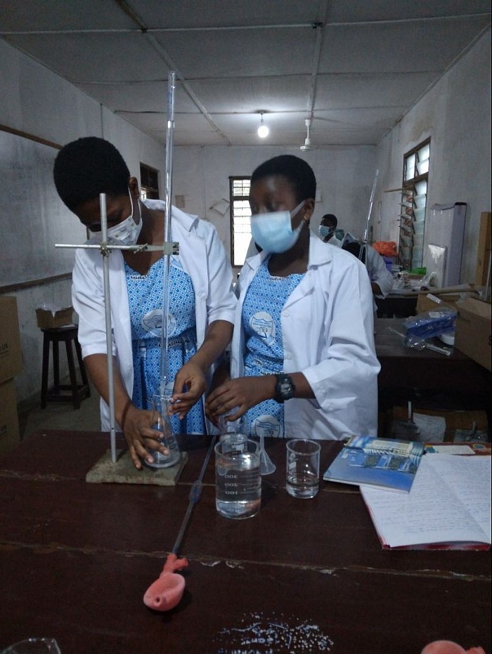 Form 1 science students performing practical exercise